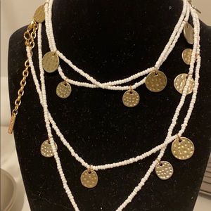 White beaded necklace with hammered gold circles